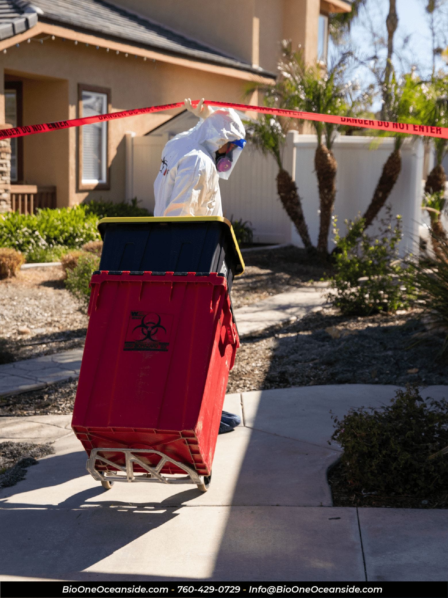 Image shows Bio-One technician entering a property with biohazard cleanup equipment.